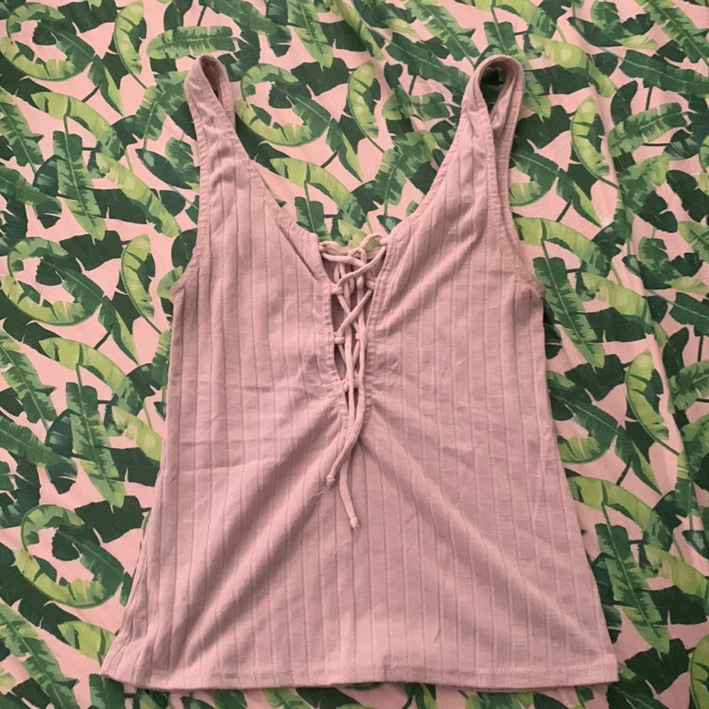 Cute slightly see through tank top with a crisscross opening down the front